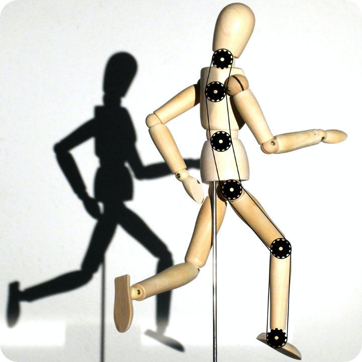 Wooden doll running with cogs and chain on joints